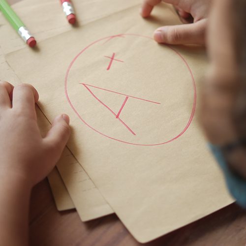 hand-holding-paper-with-hand-drawn-grade-with-plus-2022-12-07-05-40-52-utc